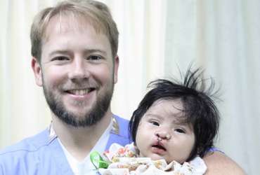 Dr. Brown with baby post-surgery